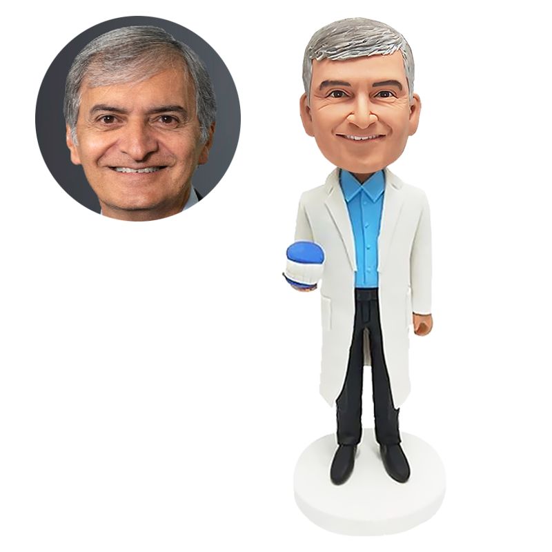 custom bobblehead figure dentist holding a set of artificial teeth